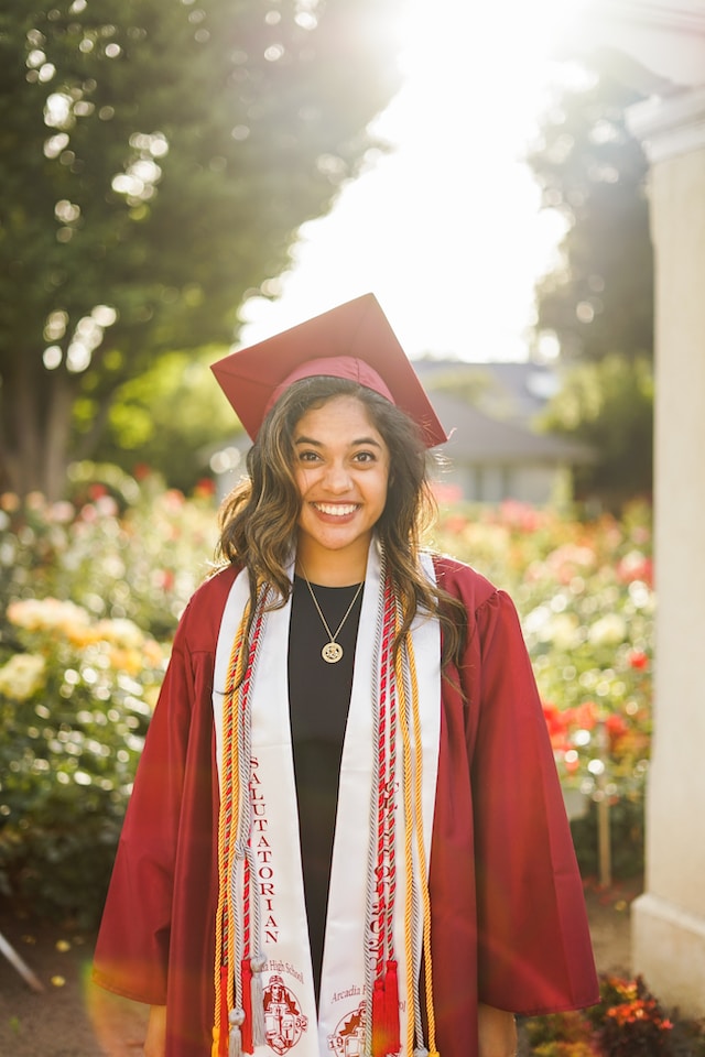 Young smilling female graduate by Conner Ching on Unsplash
